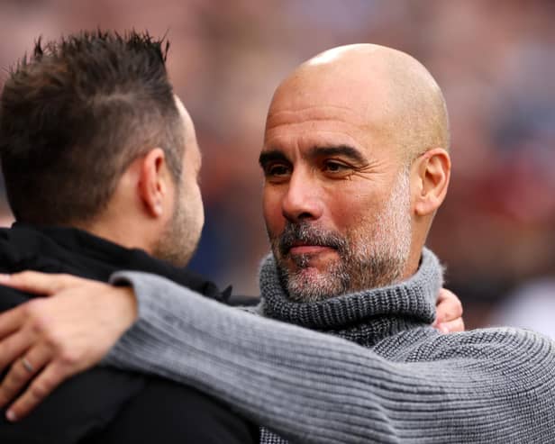 Roberto De Zerbi, manager of Brighton and Hove Albion, was greeted by Manchester City boss Pep Guardiola, prior to the Premier League match at the Etihad Stadium. (Photo by Naomi Baker/Getty Images)