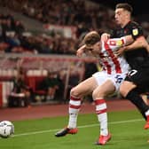 STOKE ON TRENT, ENGLAND - OCTOBER 01: Harry Souttar of Stoke City and Jordan Hugill of West Bromwich compete for the ball during the Sky Bet Championship match between Stoke City and West Bromwich Albion at Bet365 Stadium on October 01, 2021 in Stoke on Trent, England. (Photo by Nathan Stirk/Getty Images)
