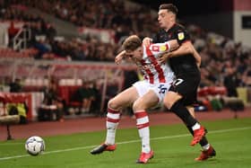 STOKE ON TRENT, ENGLAND - OCTOBER 01: Harry Souttar of Stoke City and Jordan Hugill of West Bromwich compete for the ball during the Sky Bet Championship match between Stoke City and West Bromwich Albion at Bet365 Stadium on October 01, 2021 in Stoke on Trent, England. (Photo by Nathan Stirk/Getty Images)