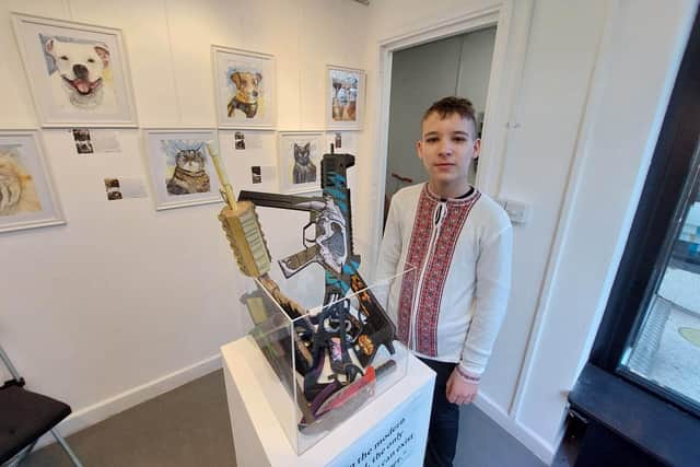 Artem Romaniv, 14, produced a eye-catching piece of work for the gallery – guns made out of paper.