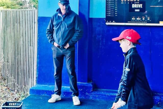Billy Stott practicing at the Slinfold Golf & Country Club Driving Range with the club's head golf pro Matt Cornall