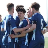 Ringmer goalscorer Oscar Morris celebrating with teammates