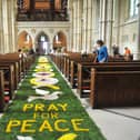 An incredible display featuring more than 8,400 flowers has been witnessed by hundreds of visitors after Arundel Cathedral unveiled its world-famous Corpus Christi Carpet of Flowers celebration
