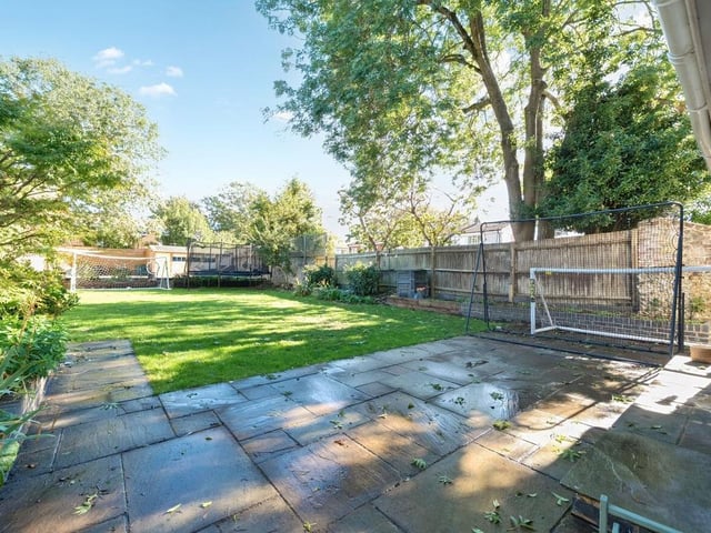 The property benefits from a well-maintained vegetable garden, a private drive and double garage, and a formal front garden