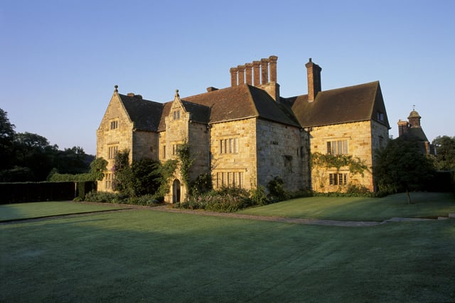 The yellow stone exterior of Bateman's in brilliant sunlight, East Sussex. Kipling bought the house, the mill and 33 acres in the summer of 1902.