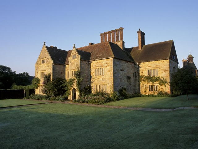 The yellow stone exterior of Bateman's in brilliant sunlight, East Sussex. Kipling bought the house, the mill and 33 acres in the summer of 1902.