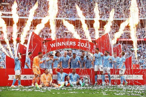 Players of Manchester City pose for a team photograph with the FA Cup after victory during the FA Cup Final between Manchester City and Manchester United at Wembley