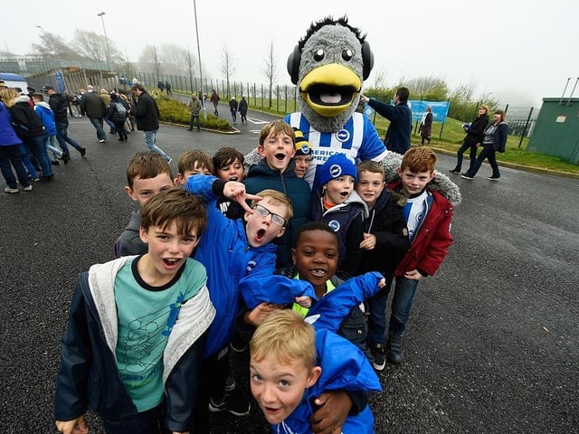 Young fans pose with Sammy the Brighton mascot prior to kick-off during the Sky Bet Championship match between Brighton and Hove Albion and Derby County at the Amex Stadium on May 2, 2016.