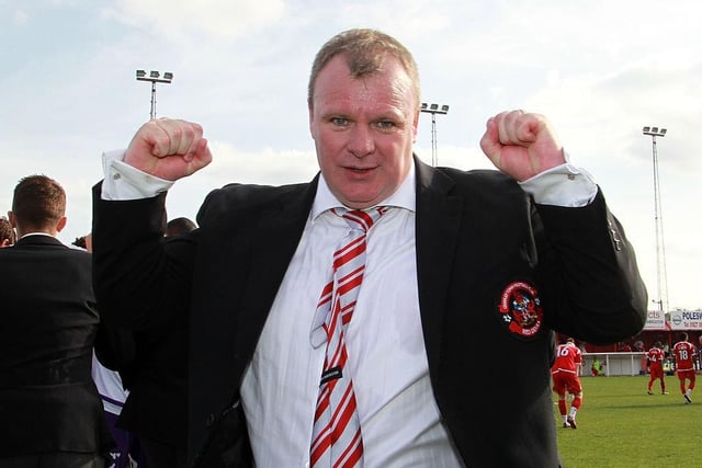 Steve Evans punches the air at the final whistle after a win over Tamworth that secured promotion to the Football League at The Lamb Ground on April 9, 2011.
