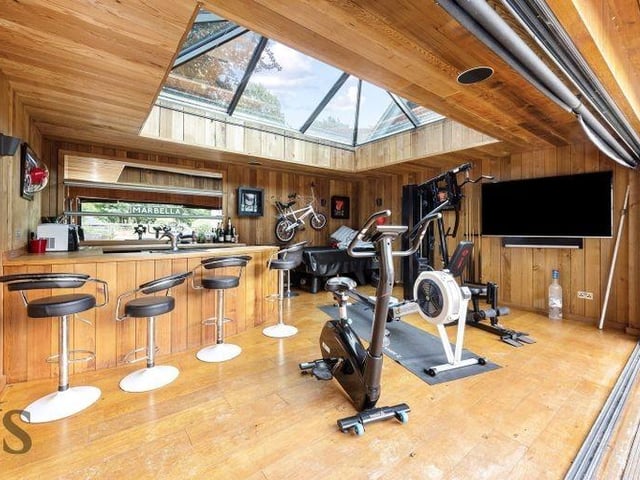In a corner of the garden is a home bar and gym