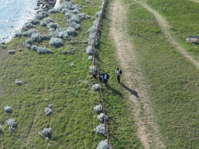 People climbing over the barrier near the cliff edge in Saltdean on Thursday, Mays 7. Photo: Eddie Mitchell