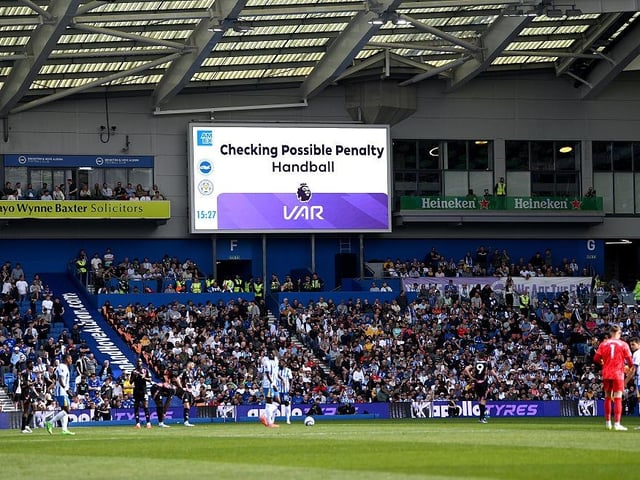 The LED screen displays a message which reads "checking possible penalty, handball"