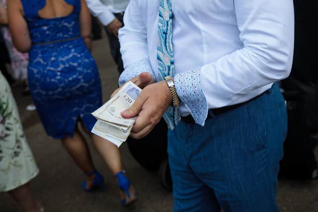 A wad of 20 pound notes (Photo by Jack Taylor/Getty Images)