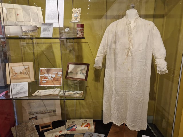 Queen Victoria’s nightdresses, with the Queen's embroidered monogram to the left of the buttons
