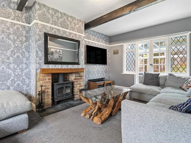 The living room has a striking fireplace and offers stunning views down to Worthing seafront