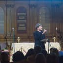 Competition judge John McCullough performing his poetry at the 2023 BHAC Poetry Festival at St George’s Church, Brighton. Photo by Abi Rose
