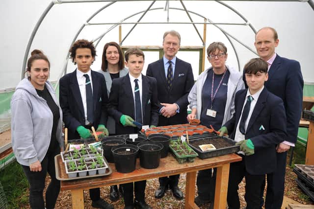 James Whitmore, High Sheriff of West Sussex 2022-23, centre, with Arun Youth Projects youth services manager Emma Biffi, Thakeham chief communications officer Claire MacAleese​, smallholding manager Toni Harris, Thakeham CSO Julian Rooney and students in the polytunnel. Picture: S Robards SR2303302