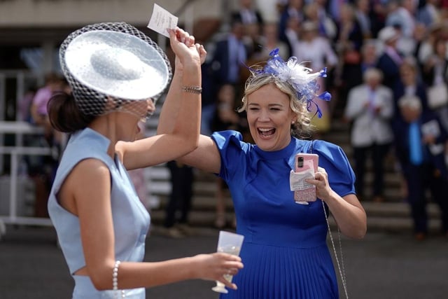 CHICHESTER, ENGLAND - AUGUST 01: Winning racegoers at Goodwood Racecourse on August 01, 2023 in Chichester, England. (Photo by Alan Crowhurst/Getty Images):Images from the opening day of the 2023 Qatar Goodwood Festival
