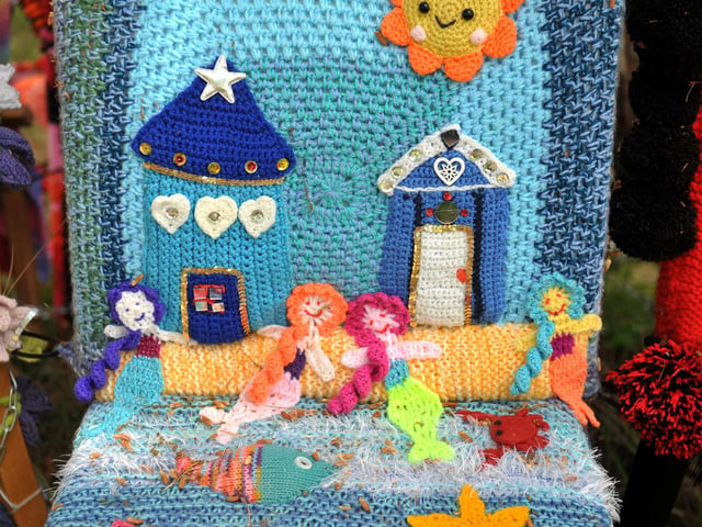 East Preston Yarnbombers have created an enchanting picnic area with chairs that are beautifully-decorated knitted masterpieces