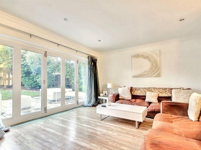 The spacious, double-aspect, L-shaped living room has bi-fold doors to the garden
