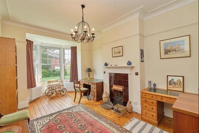 The study has a feature fireplace, stripped wooden floorboards and bay window into the rear garden.