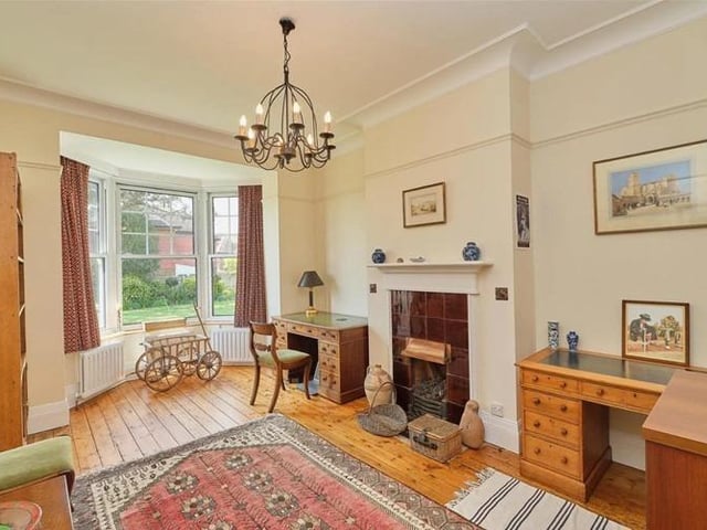 The study has a feature fireplace, stripped wooden floorboards and bay window into the rear garden.