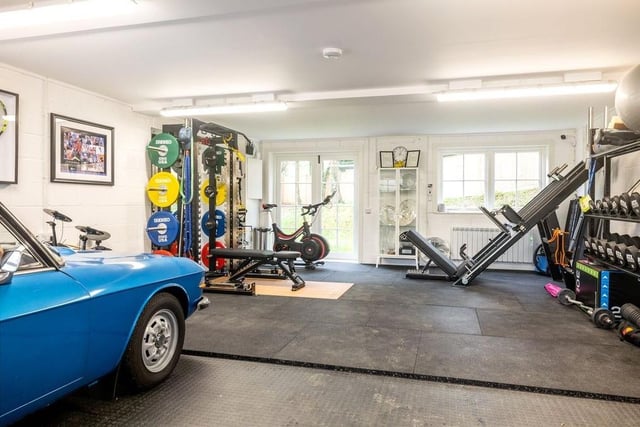 The detached four-car garage is currently being used as a gym