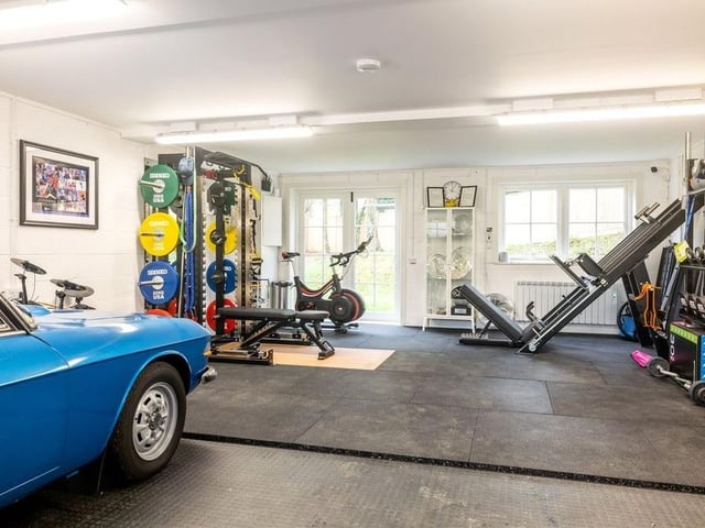 The detached four-car garage is currently being used as a gym