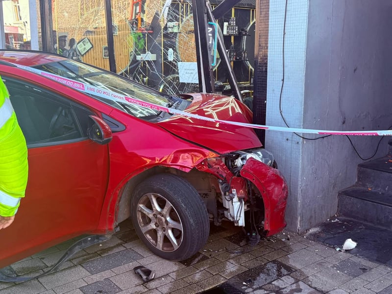 Photos from the scene show a red car had mounted the pavement, and collided directly into the front of a High Street barbershop.