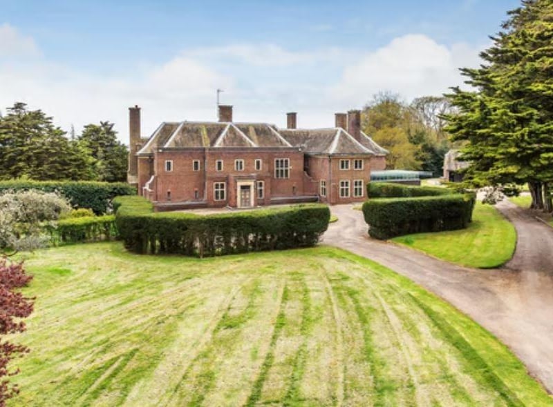 The grounds include gardens, a swimming pool, tennis court and children's playground