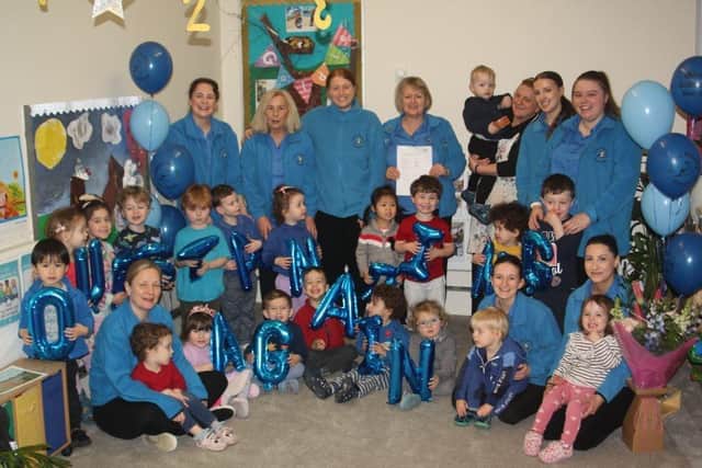 Children and staff at Catkins Nursery in Horsham celebrate after being rated 'Outstanding' by Ofsted