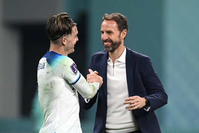 DOHA, QATAR - NOVEMBER 21: Gareth Southgate and Jack Grealish of England celebrate after their sides victory during the FIFA World Cup Qatar 2022 Group B match between England and IR Iran at Khalifa International Stadium on November 21, 2022 in Doha, Qatar. (Photo by Matthias Hangst/Getty Images)
