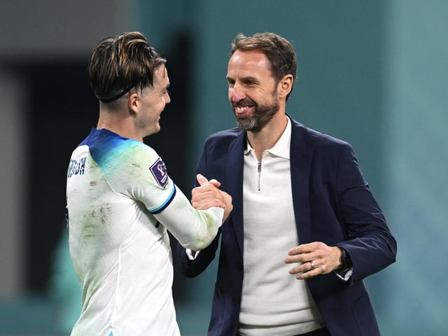 DOHA, QATAR - NOVEMBER 21: Gareth Southgate and Jack Grealish of England celebrate after their sides victory during the FIFA World Cup Qatar 2022 Group B match between England and IR Iran at Khalifa International Stadium on November 21, 2022 in Doha, Qatar. (Photo by Matthias Hangst/Getty Images)