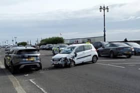 A damaged car and a police vehicle on Marine Parade in Worthing. Photo: Sussex News and Pictures