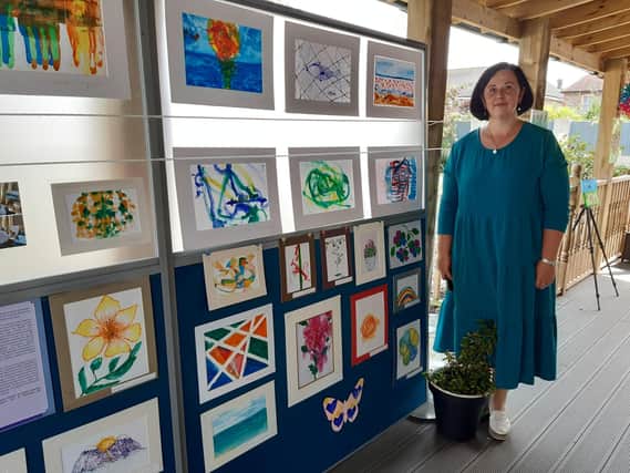 Art therapist Joana Lebedeva with the Art on the Trail exhibition at St Winefrides Residential Home in Littlehampton