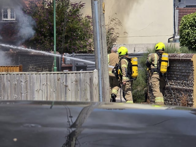 Firefighters tackle a blaze that destroyed two sheds, on Beaconsfield Road