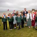 Helena Dollimore MP, Heritage Minister Baroness Twycross, and local school children at Hastings Castle celebrating a blockbuster year for Hastings' Norman heritage.