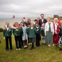 Helena Dollimore MP, Heritage Minister Baroness Twycross, and local school children at Hastings Castle celebrating a blockbuster year for Hastings' Norman heritage.