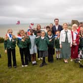Helena Dollimore MP, Heritage Minister Baroness Twycross, and local school children at Hastings Castle celebrating a blockbuster year for Hastings' Norman heritage.