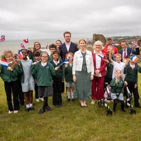 Helena Dollimore MP, Heritage Minister Baroness Twycross, and local school children at Hastings Castle celebrating a blockbuster year for Hastings' Norman heritage.