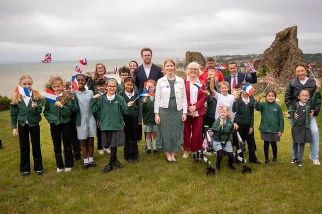 Helena Dollimore MP, Heritage Minister Baroness Twycross, and local school children at Hastings Castle celebrating a blockbuster year for Hastings' Norman heritage.