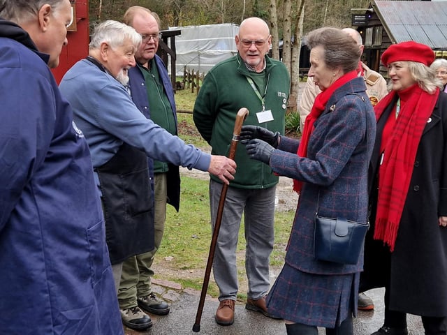 Volunteer Ken Wood presents the Princess Royal with a wooden walking stick he had made by hand