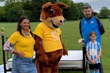 Chestnut Tree House community fundraiser Caroline Roberts-Quigley and mascot Sidney the squirrel at Worthing United Youth FC ahead of the CharityBedPush