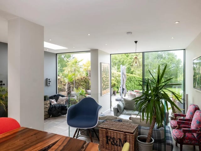 The open plan kitchen/dining/sitting room features two sets of glazed doors to the garden