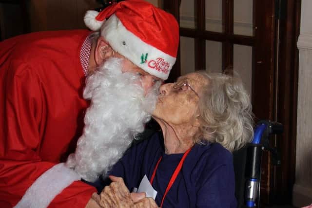 Audrey Batt steals a kiss from Santa