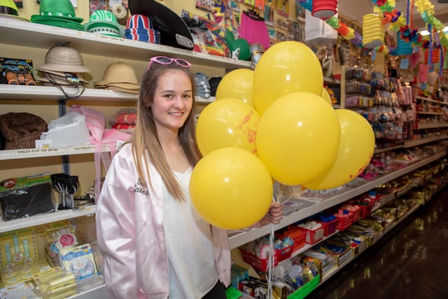 Shop assistant Jade Thompson (19) holds balloons as U-Need-Us celebrated its 95th anniversary in 2018. Picture: Vernon Nash (180396-003)
