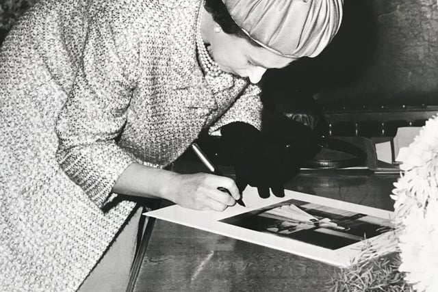 The Queen signs a book at Eastbourne Town Hall on her visit to the town in 1966