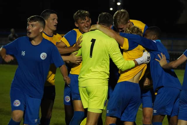 Chris Winterton is mobbed by Eastbourne Town teammates after his penalty heroics in the FA Cup | Picture: Josh Claxton