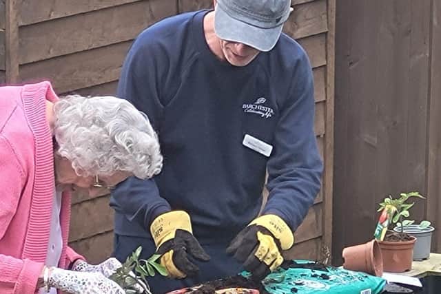Hazel Lodge's gardener Richard being shown how it's done by resident Sylvia.