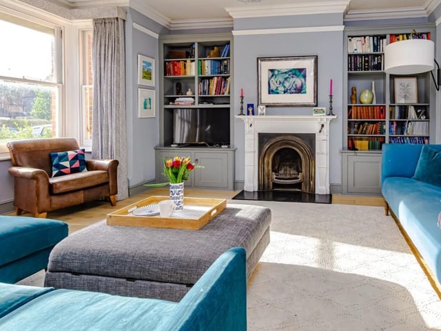 There is a bay fronted sitting room with lots of space for sofas and chairs